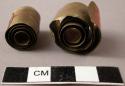 Rolls of thin brass plate - used in enlarging the hole in the ears +