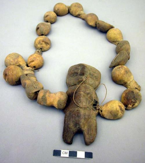 Bone necklace with wooden figurine or toy (toy perhaps added recently)