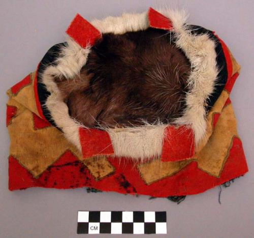 Pouch, hide and fur circular base, exterior red wool with beige applique designs