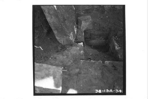 Capstones removed from cist under stairway, Str 11; North side