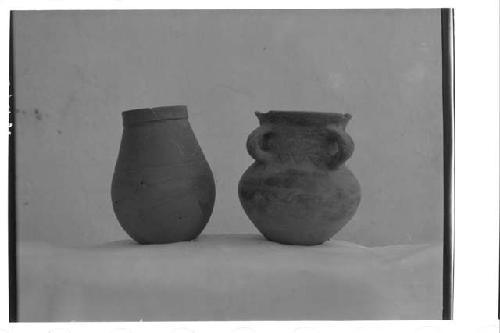 Left, fine orange ware jar, grooves. Left, small 4-handled jar with crude incisi