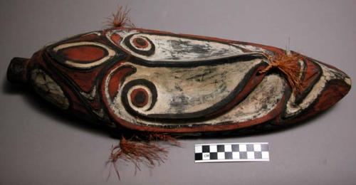 Carved wooden head - painted red, white and black