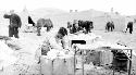 People setting up desks and tents in desert