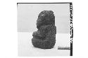 Small seated stone figure (left side and back)