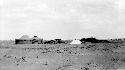 Huts and tent in desert