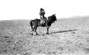 Person riding pony in desert