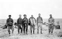 Group of people standing in desert