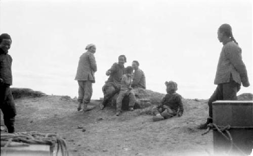 People with boxes in desert