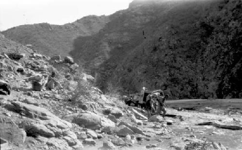 People walking by mountains