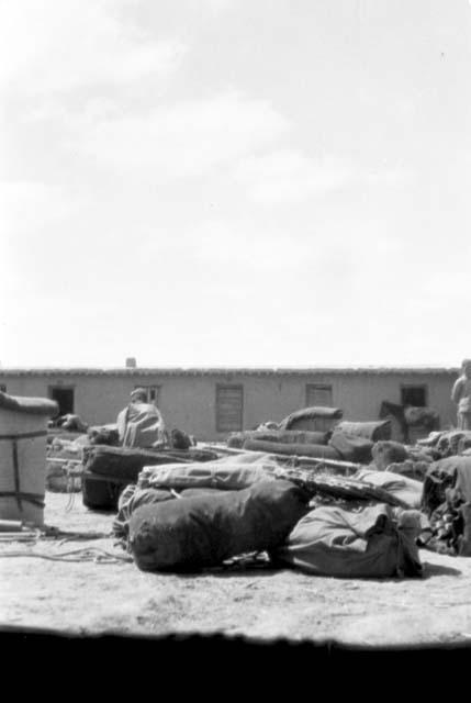 Man standing by packs outside of building