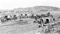 People and horses with carts in the desert