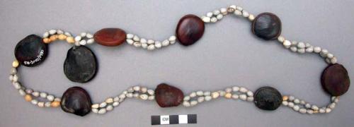 Seed necklace, small gray seeds and larger brown seeds.