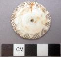 Breast ornament, etched edge of shell disc