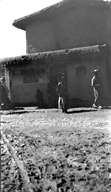 Two people standing outside of a building