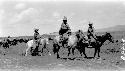 People riding ponies in the desert