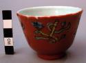 Porcelain Tea Cup with Orange Glaze and Green and Blue Floral Design