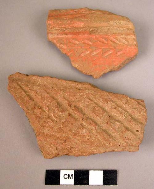 2 potsherds - coarse red grooved incised ware