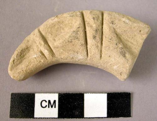 Incised clay horn-shaped object