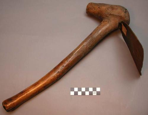 Hoe with iron blade and wooden handle, worked by a native blacksmith