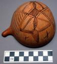 Gourd container, 1/2 sphere, hollowed, perforated near stem, burnt linear deco