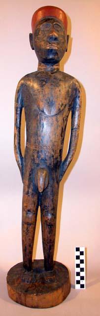 Carved wooden human figure - conventional style; black with red hair