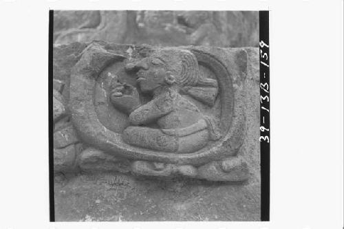 Part of lowest sculptured step with seated figure