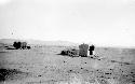 Small hut in desert, mountains in distance