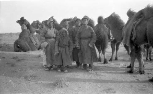 People and camels in desert