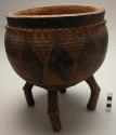 Wood bowl; 4 bent legs; round body; diamond-shaped & incised designs