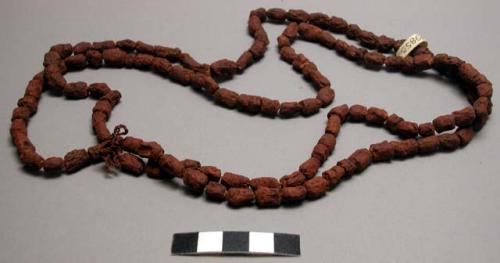 Tambuti - string of wooden beads, rubbed with grease and red powdered stone