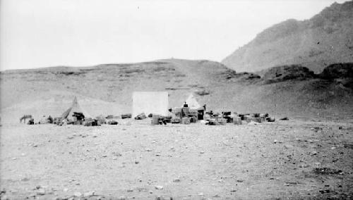 Tents and boxes in desert