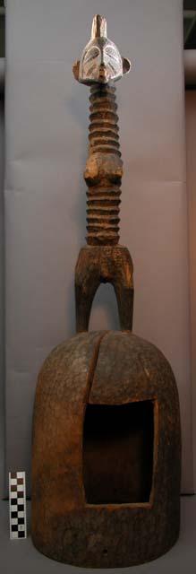 Helmet mask with carved figure of female on top (wood)