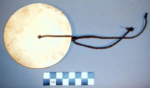 Chief's badge--large shell disc perforated in center, rope through hole