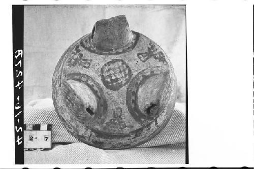 Tripodal, dichrome pottery bowl.