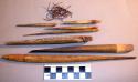 Spear fragments, bone points of various sizes, degrading fiber cord, pigmented