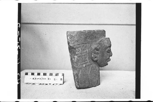 Fragmentary carved stone figure.