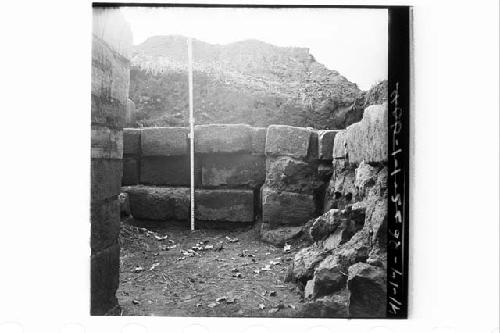 Stones of ext. W wall near NW corner.  View along N side of stone platform to W.