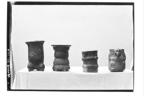 Pottery vessels (4).  1-(Left) Pol. red tripod-rattles in feet-app. a single plu