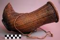Basket worn by men on the back for carrying sickle, pipe, etc.