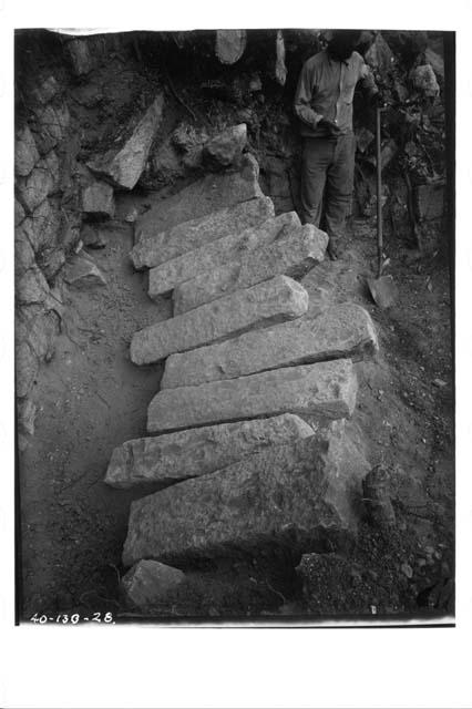 Row of fallen capstones in room of mound 9