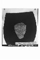 Carved stone grotesque face from Altar A (cat. #40b-1-1/11).  Face made of hard