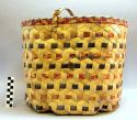 Rectangular carrying basket with hexagonal bottom. Decorated with red +