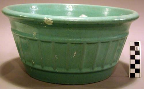 Ceramic mixing bowl. aqua blue glaze, flaring sides with a linear vertical desi