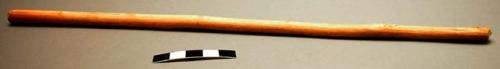 2 piece musical instrument - wooden bow notched on one side, strung with a reed.