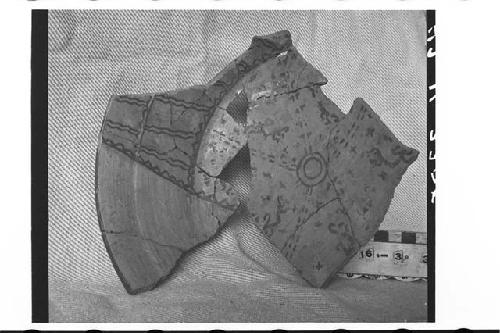 Fragmentary tetrapodal pottery bowl.