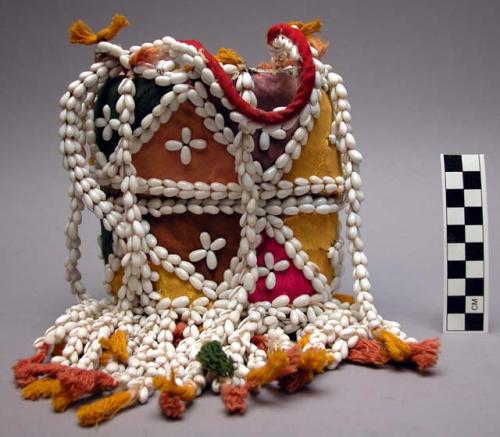 Bag-like basket with cover, decorated with cowrie shells and colored cloth
