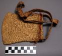 Man's small basket used as hand bag. Made by women.