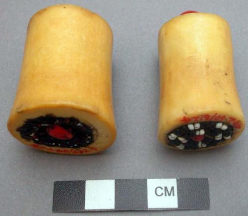 Woman's ornamental ear plugs - bone, cylindrical shape, decorated at both ends