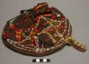 Skin carrying bag. pouch-shaped; with handle; dyed brown; richly decorated with