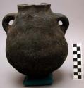Black pot, handle on each side, incised decoration, circumference 21 5/8"